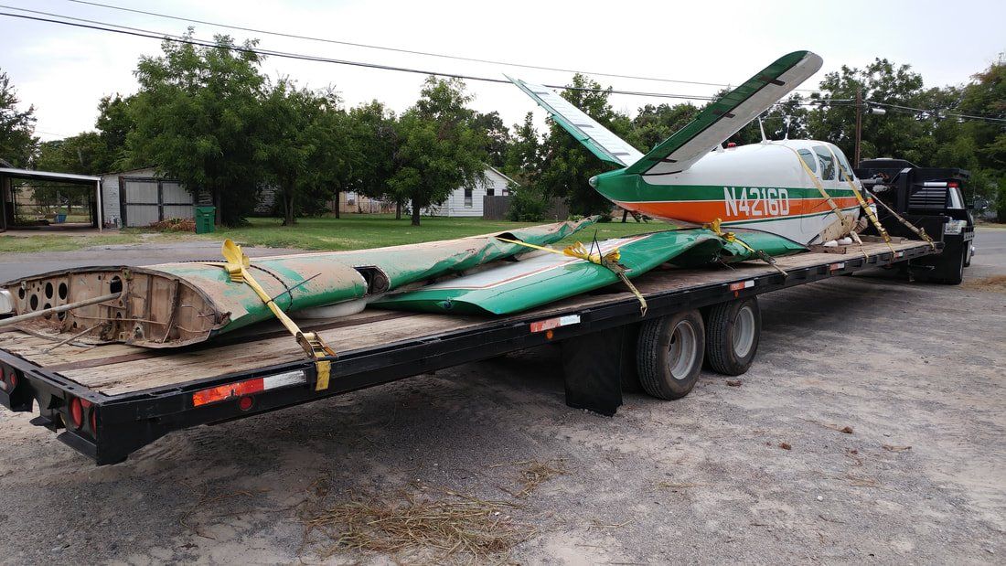 A small plane is sitting on top of a trailer.