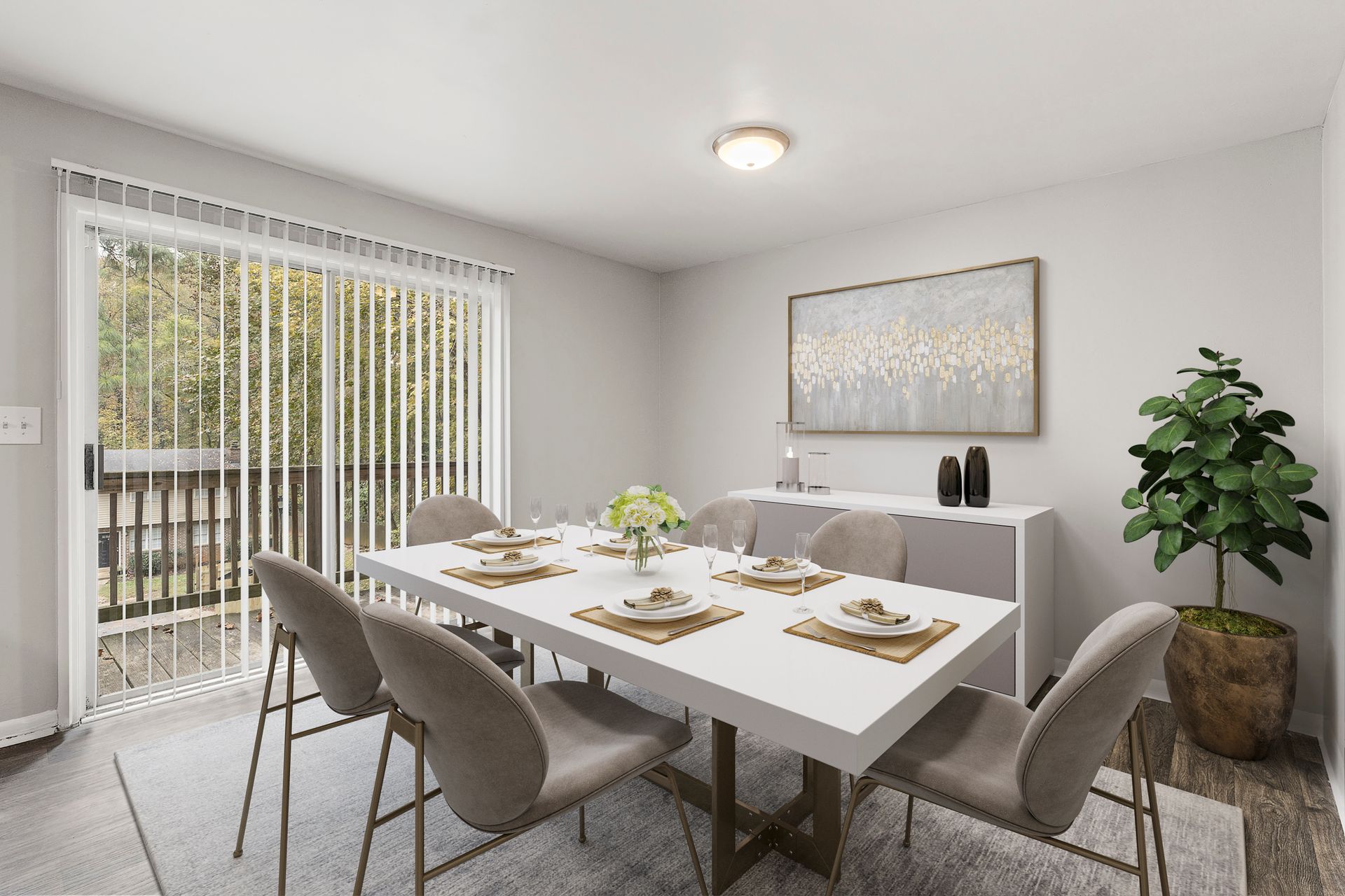 Modern dining room with a white table, gray chairs, large window, and potted plant.