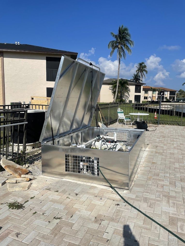 A stainless steel box with a hose attached to it