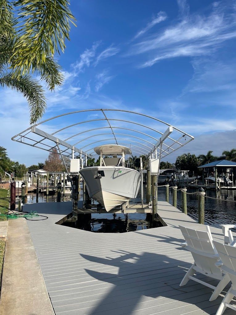 A boat is sitting on top of a dock under a canopy.