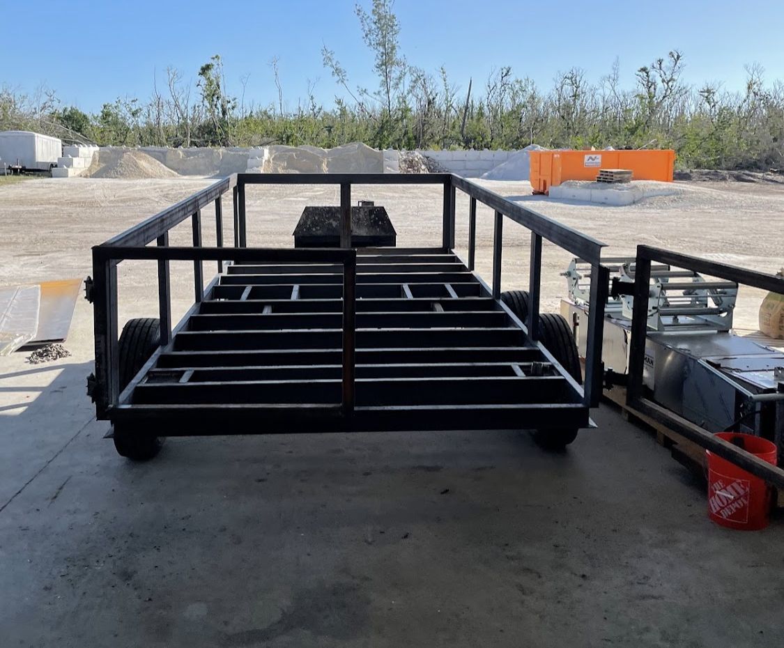 A trailer is sitting on the ground in a parking lot.
