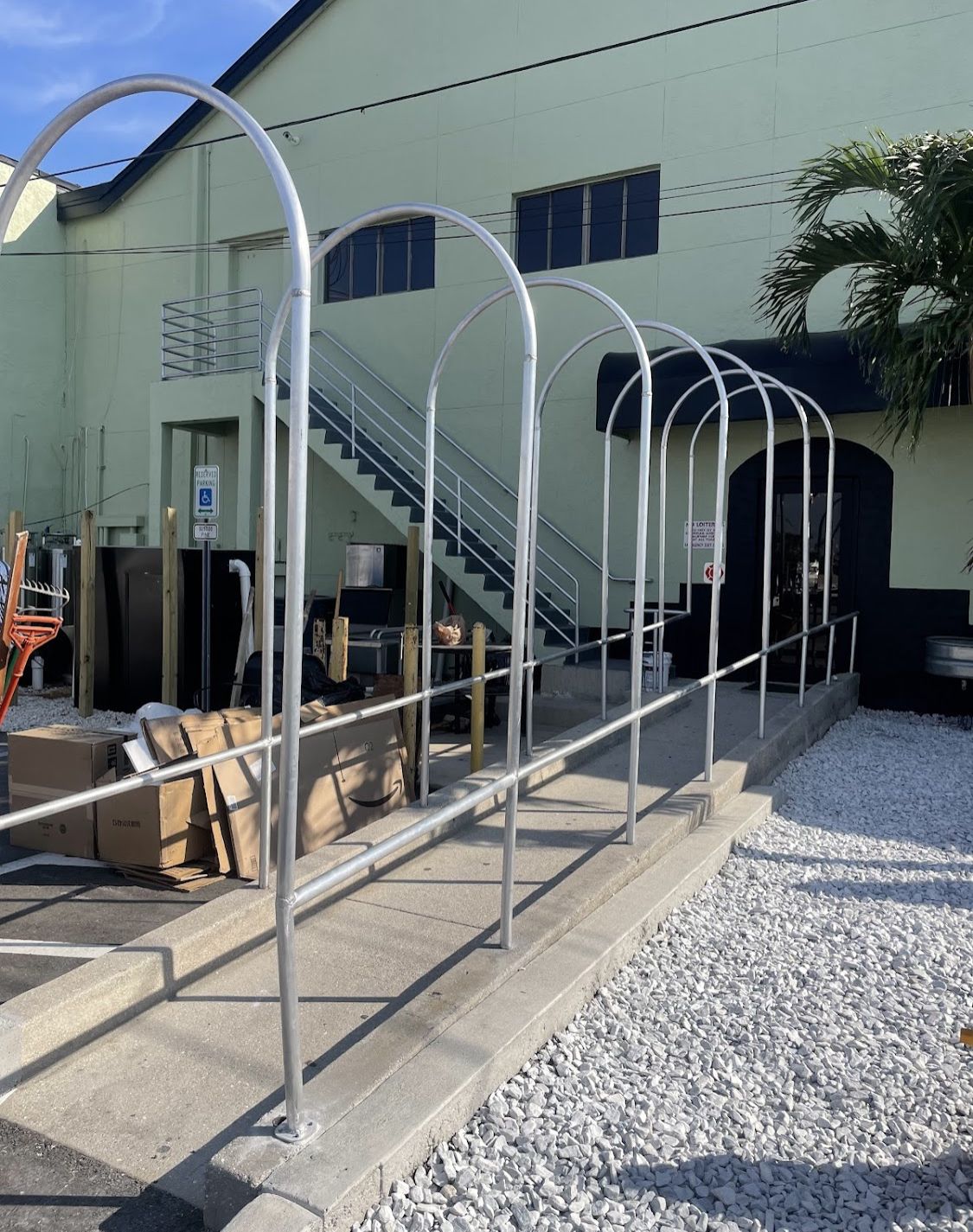 A row of metal arches in front of a building