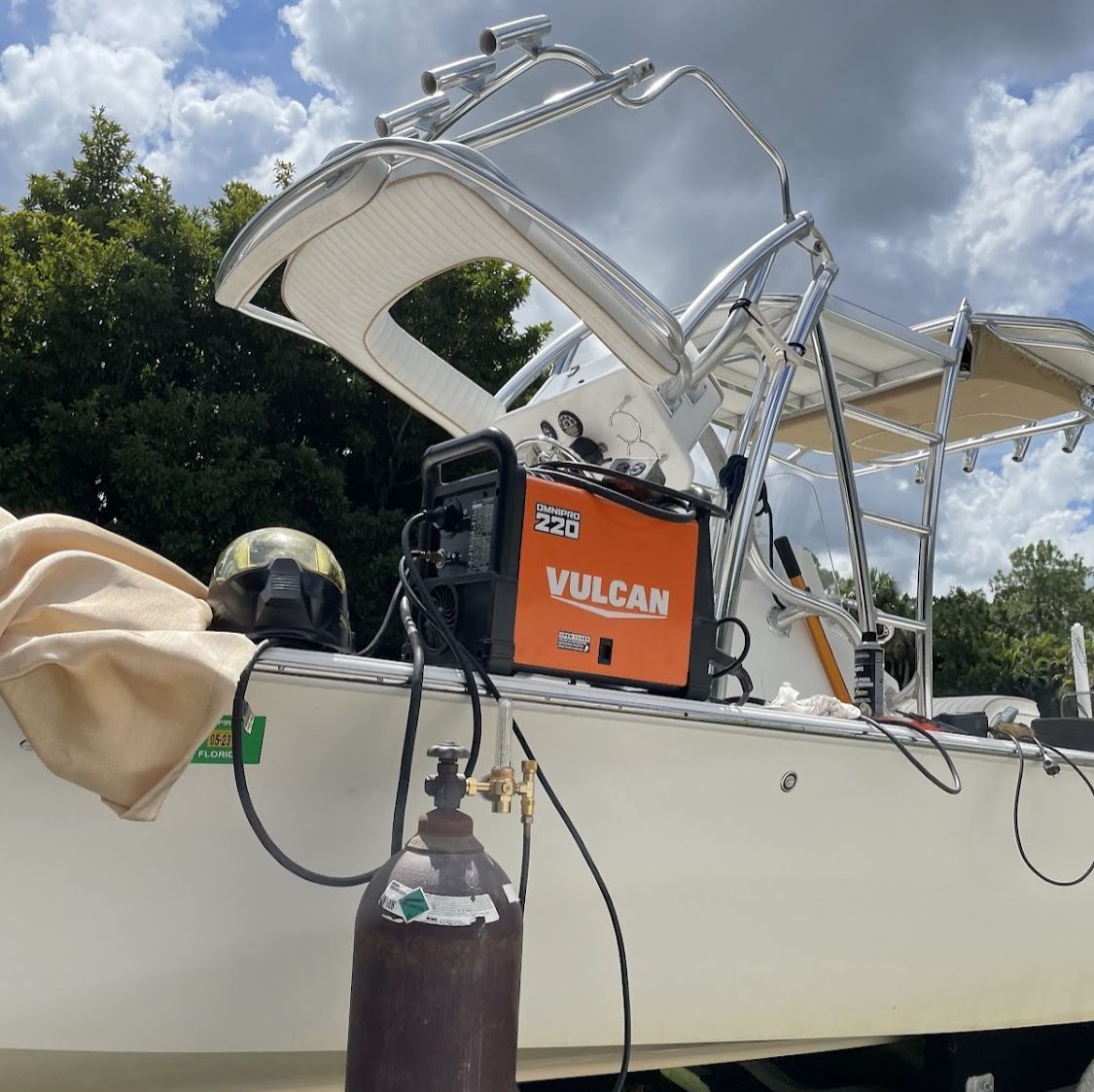 A vulcan welding machine is attached to the side of a boat