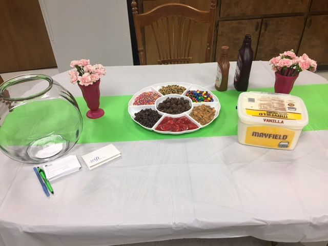 A table with a tray of food and flowers on it.