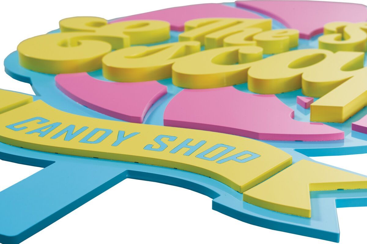 Colorful laser-cut acrylic dimensional sign for Sweet Escape Candy Shop