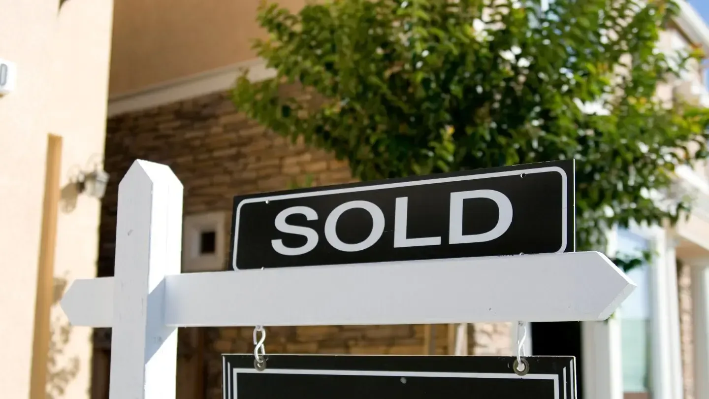 A sold sign is in front of a house