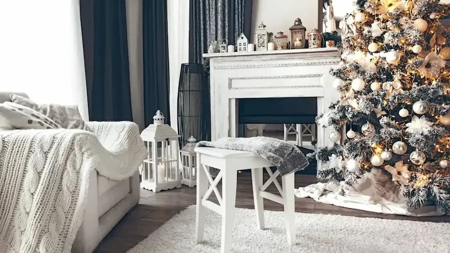 a living room with a fireplace and a christmas tree