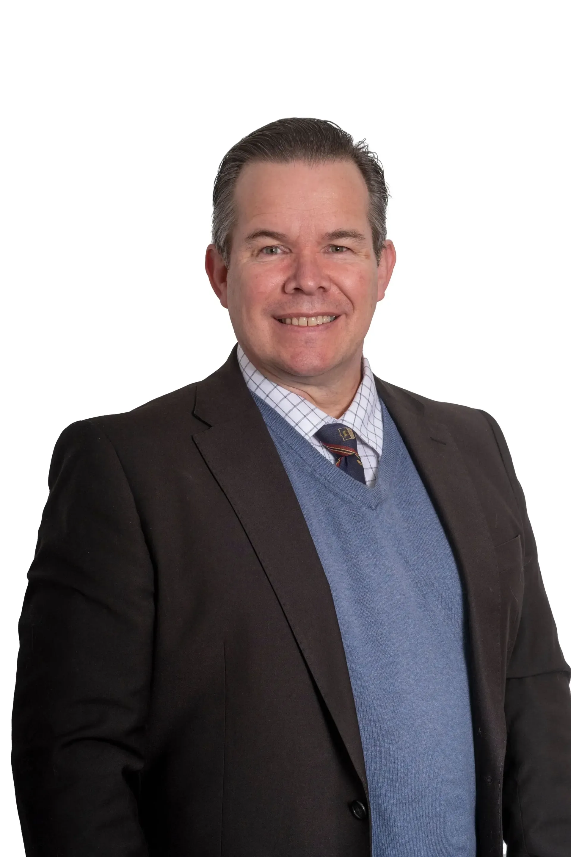 Frank Sherriff in a suit and tie is smiling for the camera.