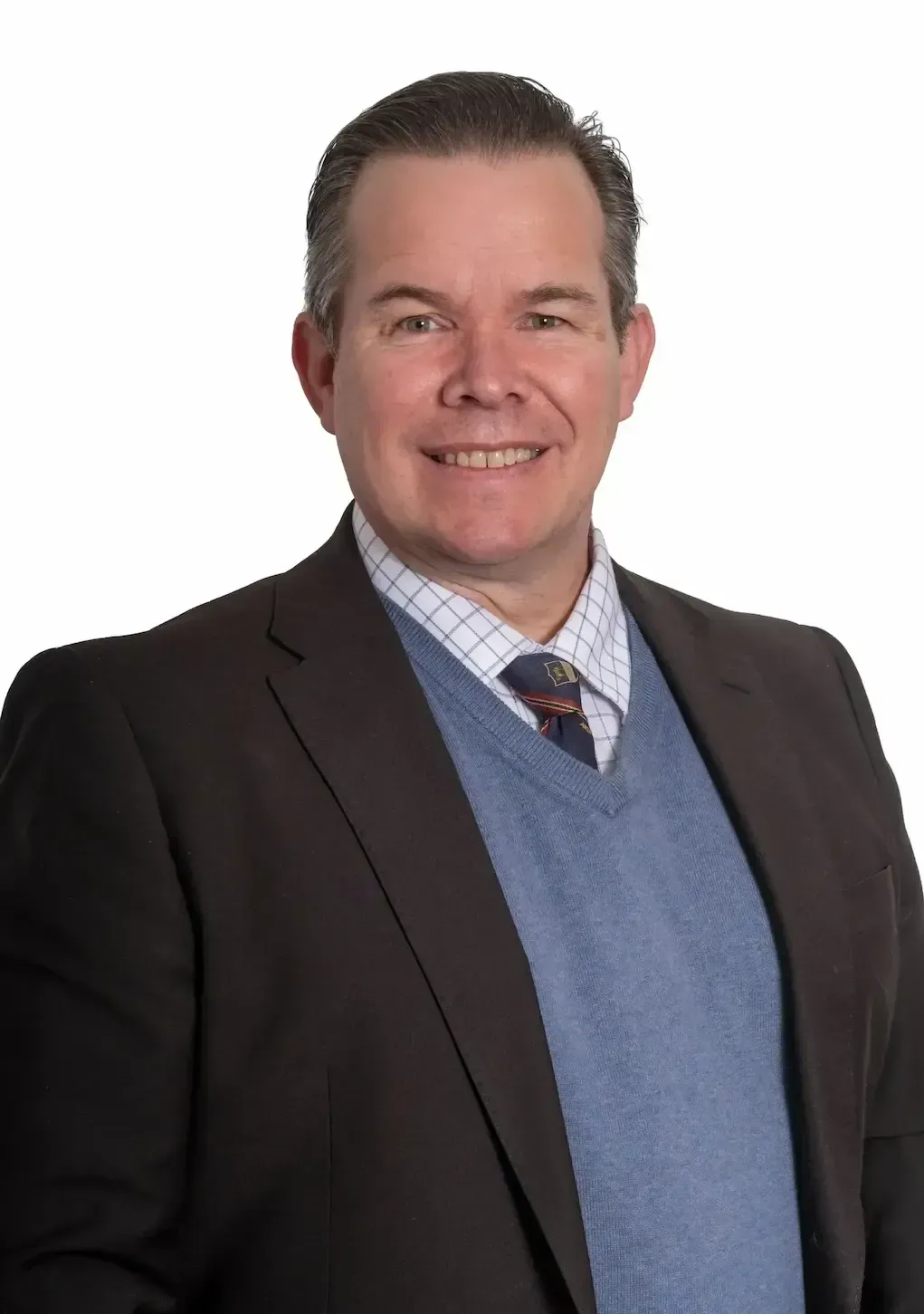 Frank Sherriff in a suit and tie is smiling for the camera.
