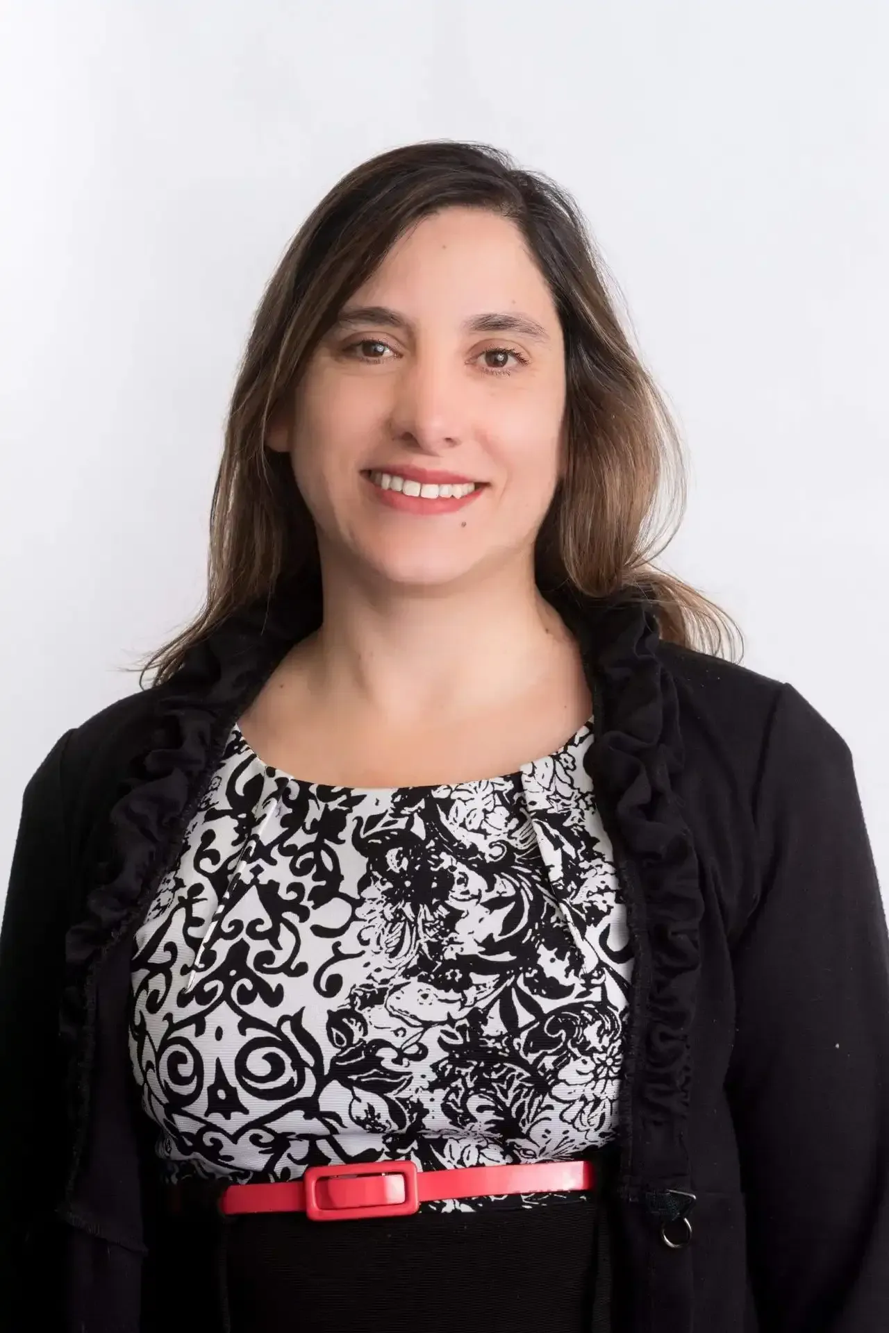Rosa Bellolio Roth wearing a black and white dress and a red belt