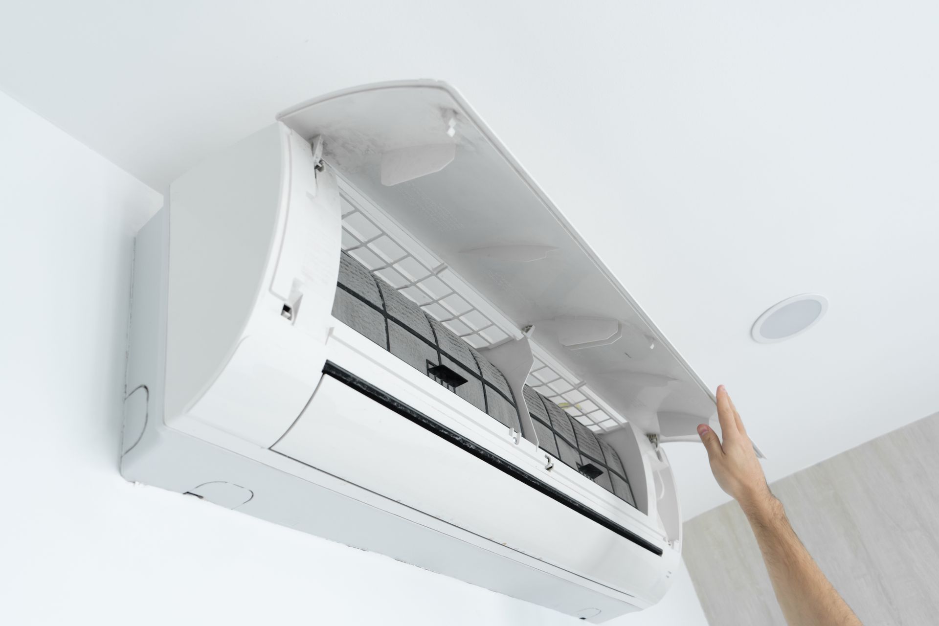 A man is inspecting an AC.