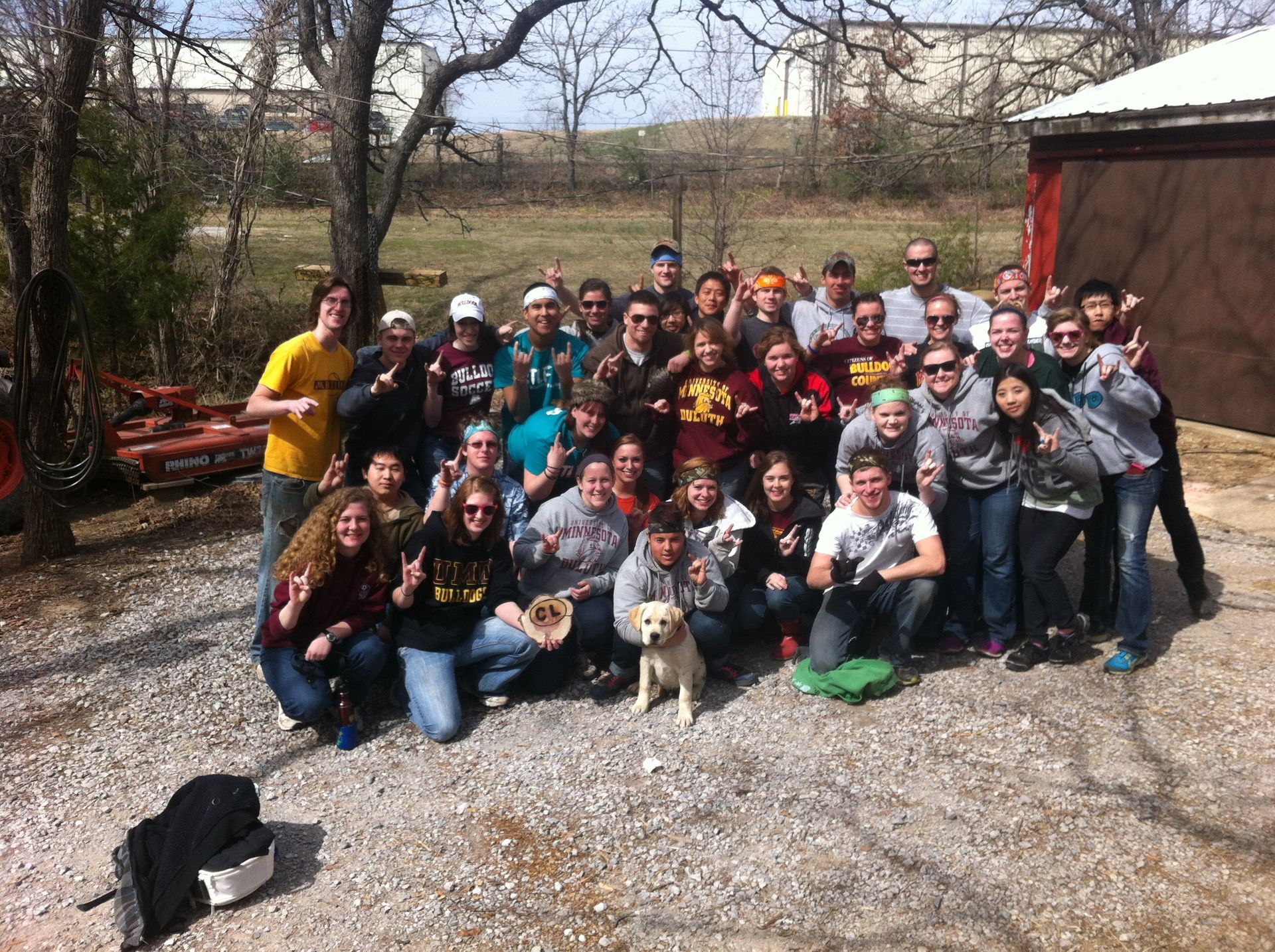 A group of people posing for a picture with a dog
