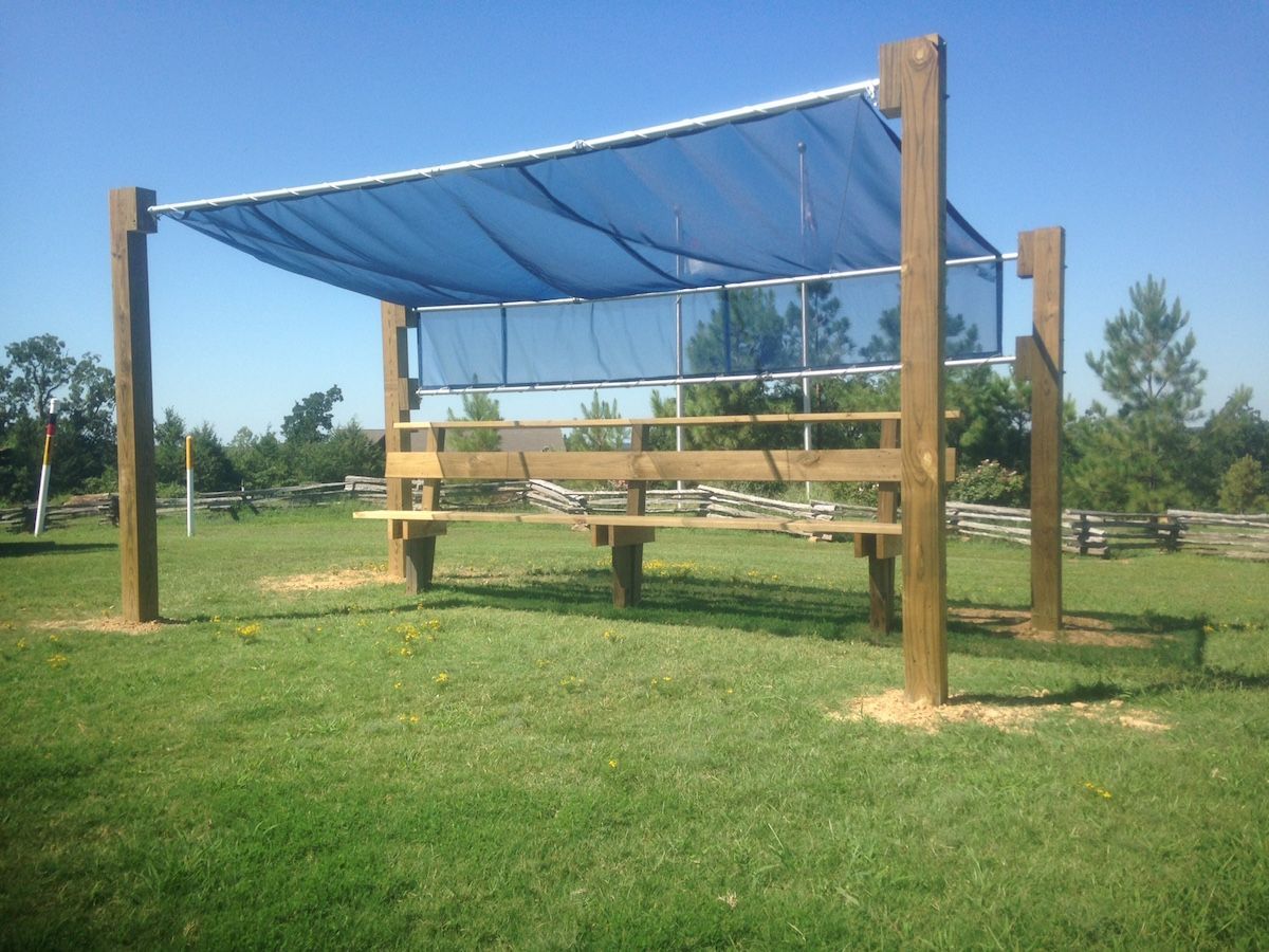 A wooden structure with a blue tarp on top of it