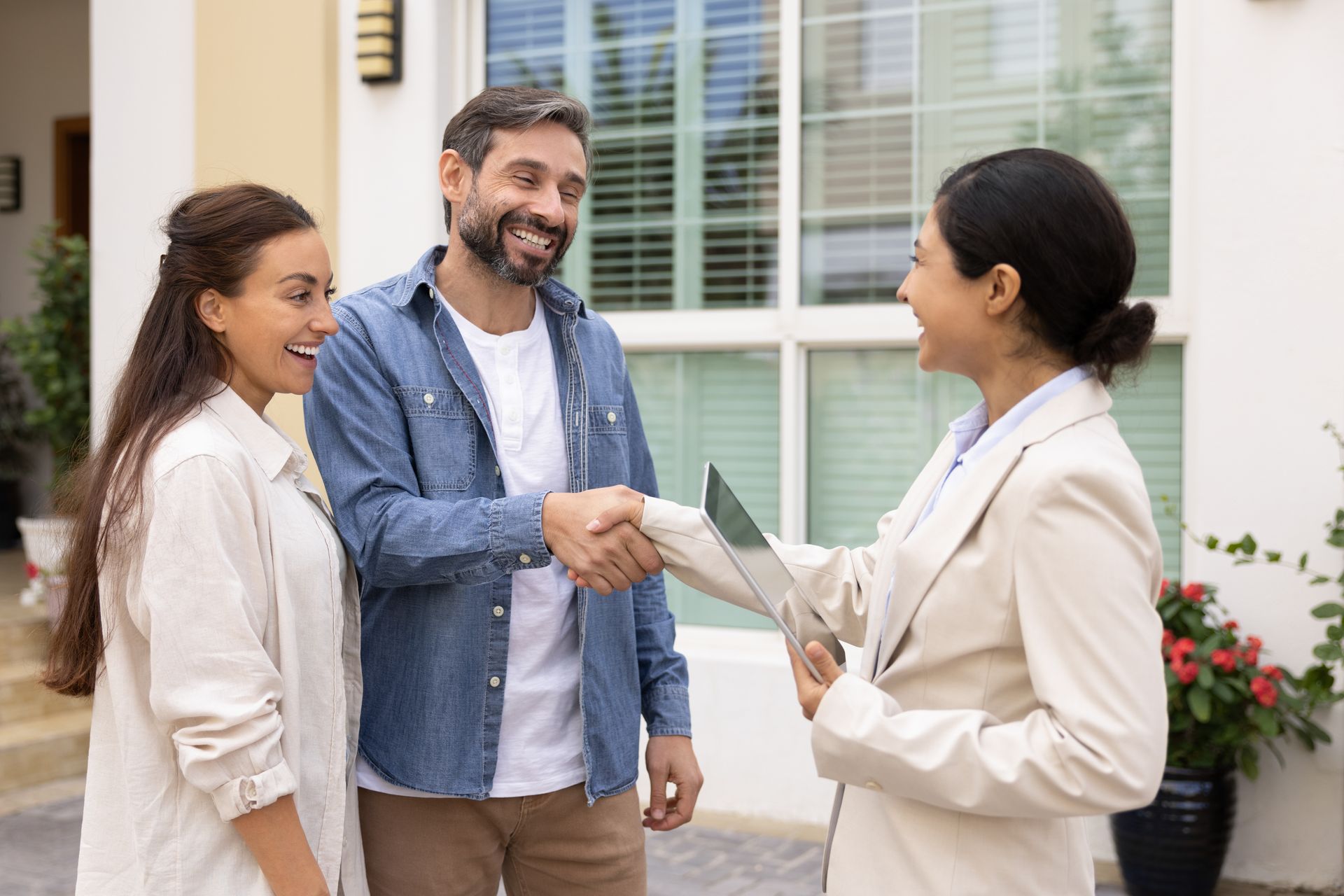 Home-buying professional making an agreement with couple selling home.