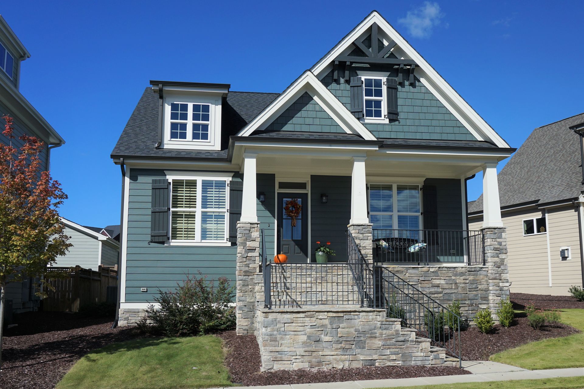 Quaint Kentucky home with blue siding and stone front porch.