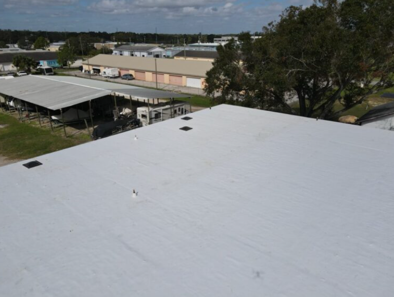 Completed white TPO roof on an Auburndale commercial property