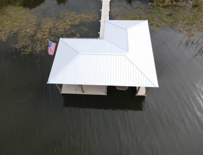Overhead drone view of a completed white metal roof on a Florida property