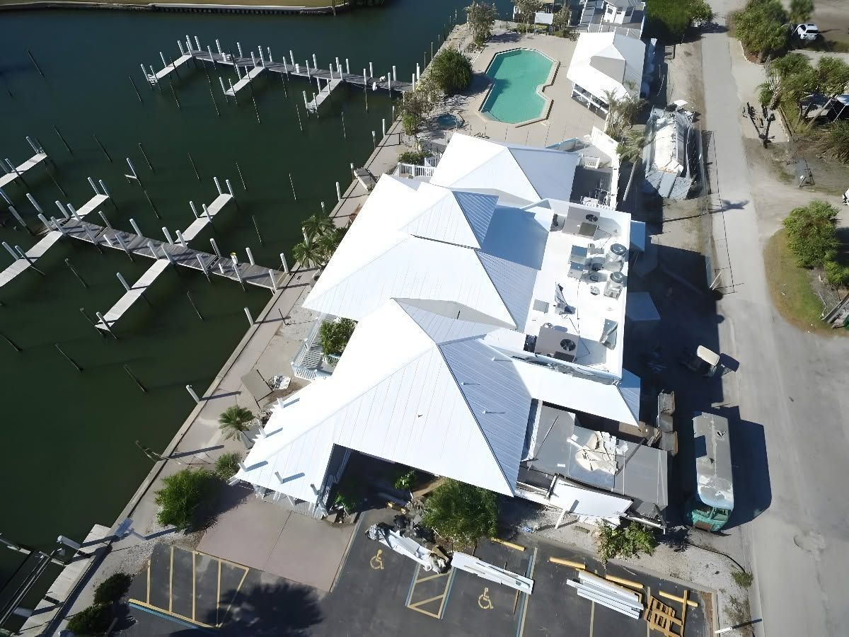 Aerial view of white metal roofs on waterfront buildings