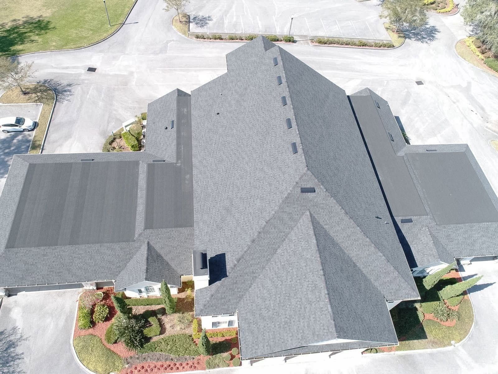 Aerial view of a completed gray shingle roof on a Florida home