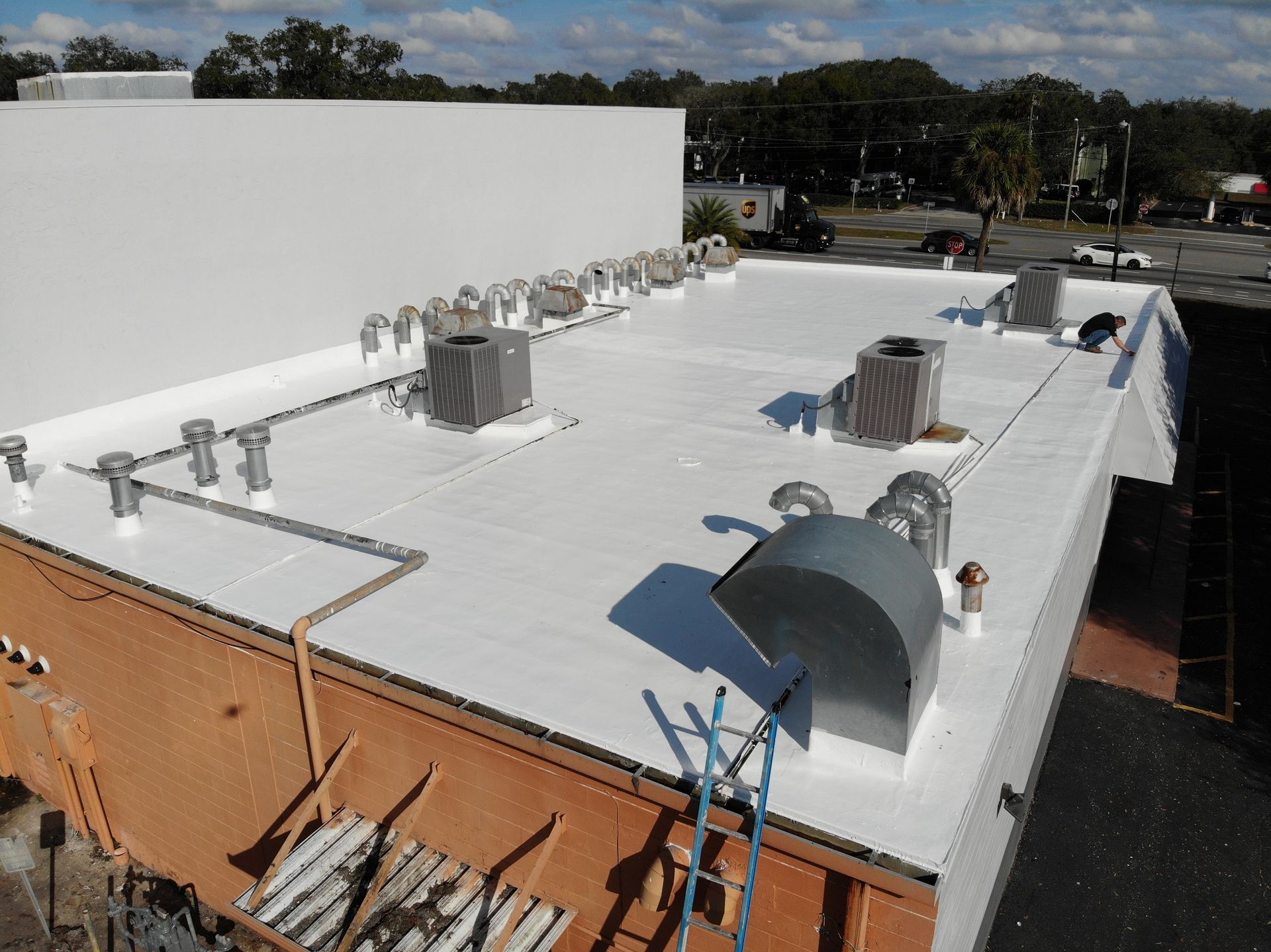 Commercial roof inspection around exhaust fans and grease-affected rooftop equipment above a Central Florida restaurant