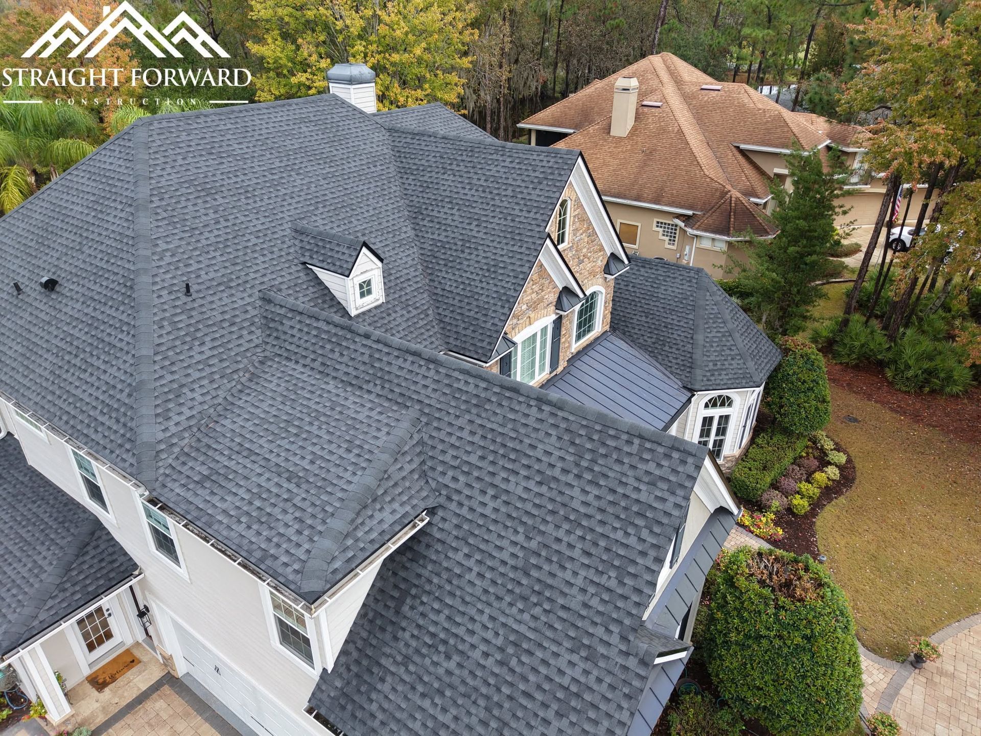 Aerial view of a completed architectural asphalt shingle roof on a large Florida home