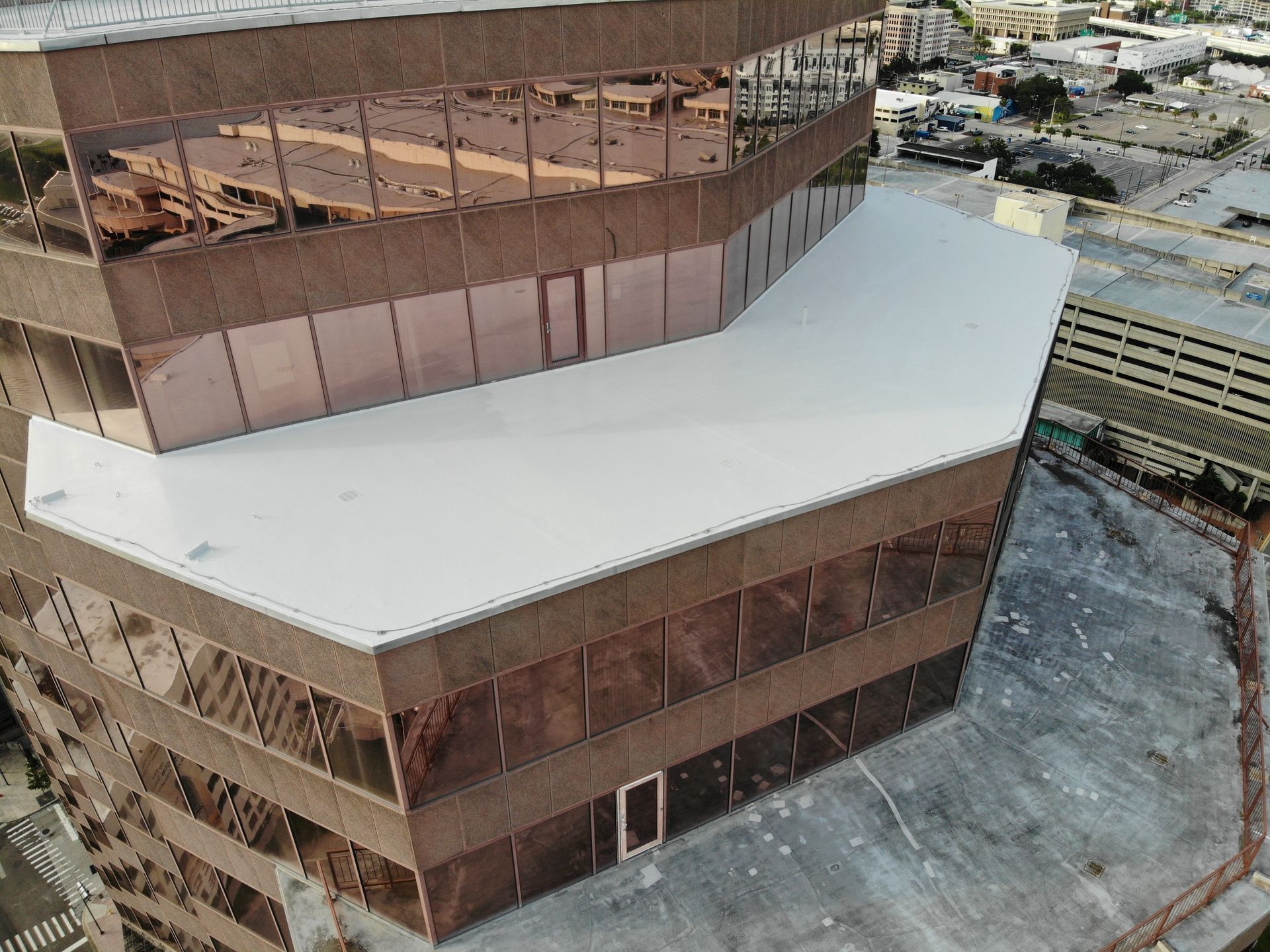 Commercial roofing work underway on a Central Florida hotel while guest entrances and operations remain protected