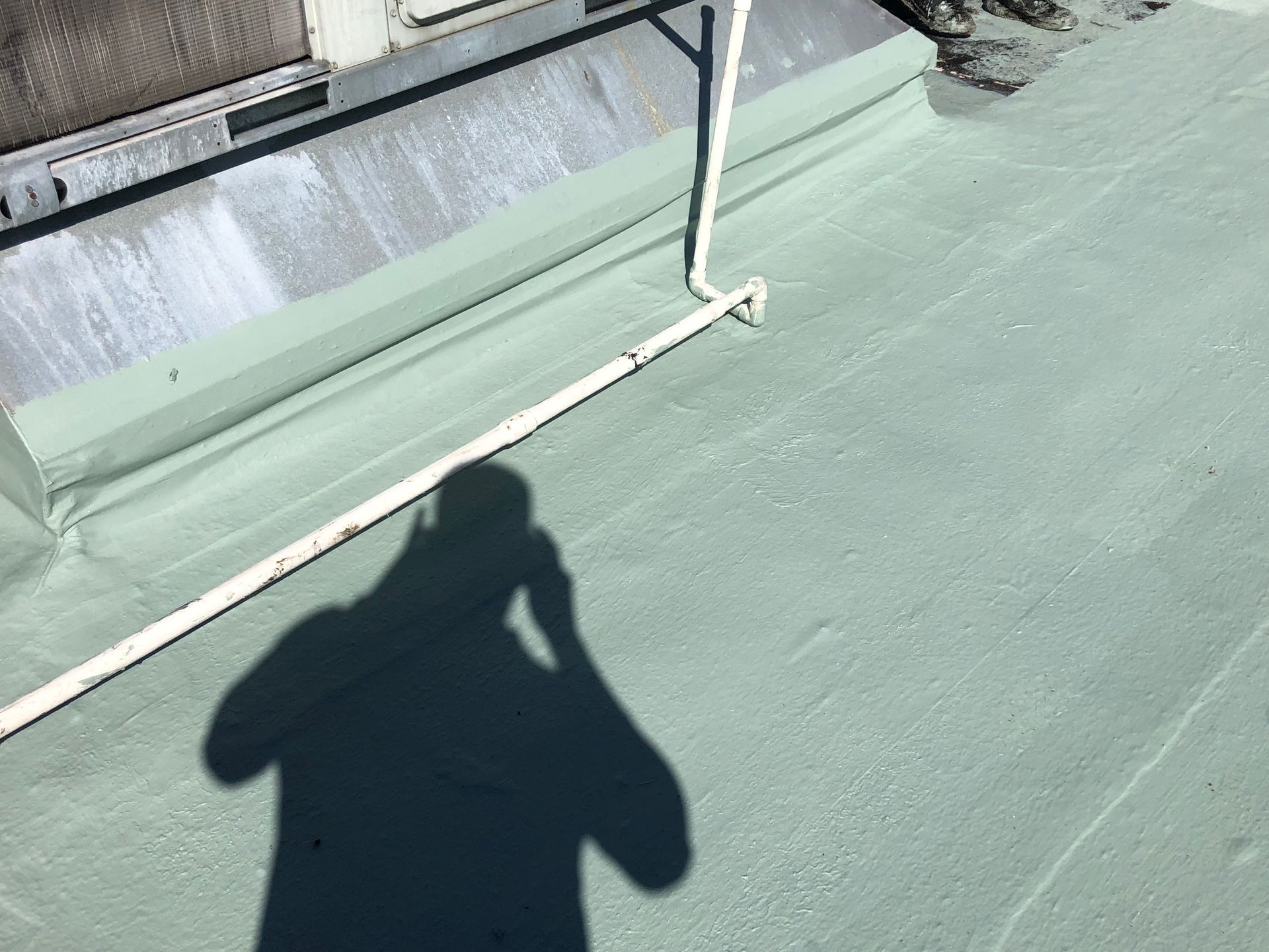 Commercial roofer documenting rooftop penetrations and drainage in Auburndale, Florida