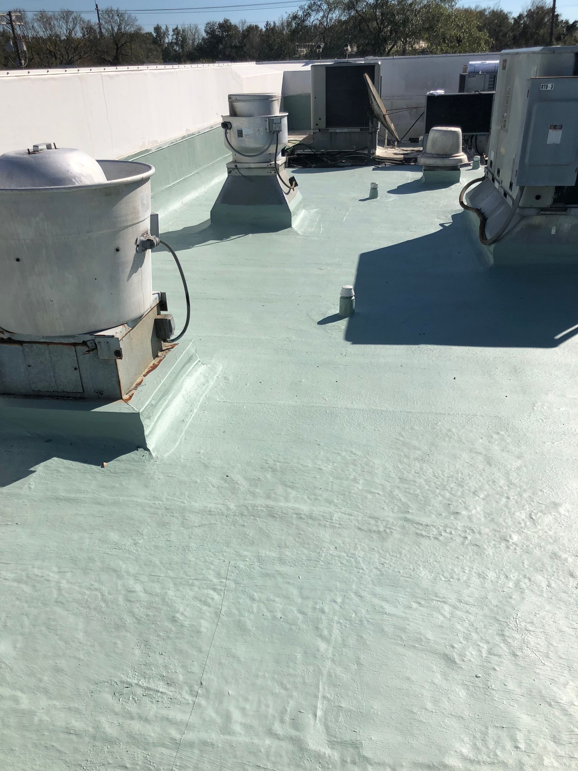 Completed reflective roof coating on an Auburndale commercial property