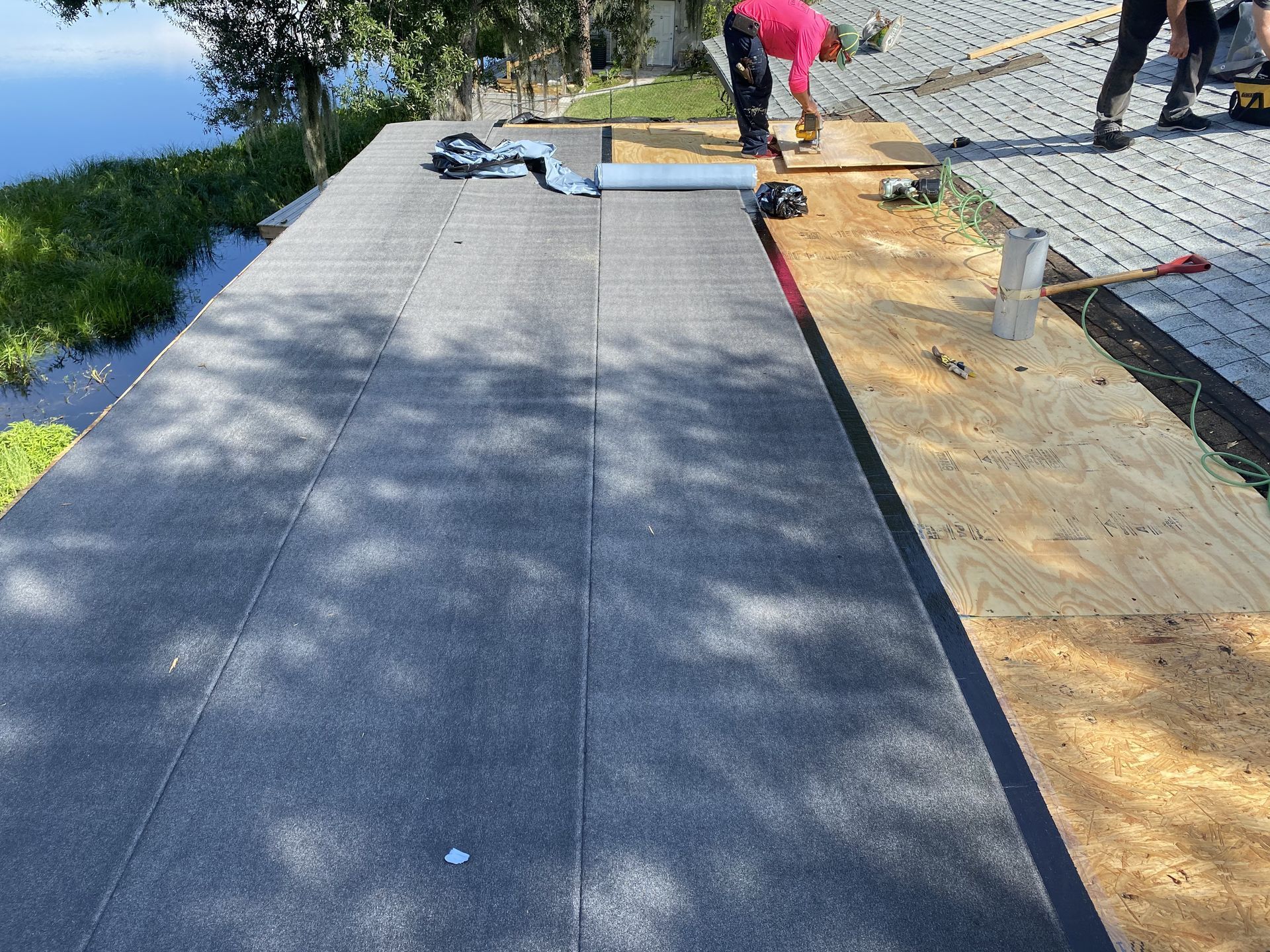Roofing contractor inspecting flashing and roof penetrations in Auburndale, Florida