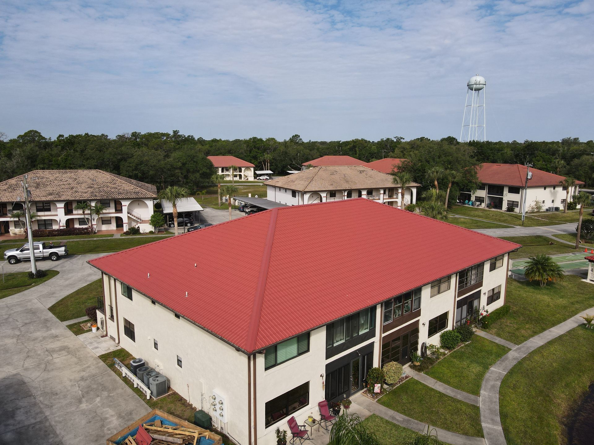 Coordinated roof replacement across a Central Florida condominium or HOA community with multiple occupied buildings