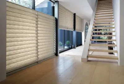 Modern interior with beige blinds, large windows, wood floor, and a white staircase with open steps