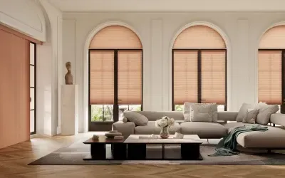 Bright modern living room with arched windows, beige sofa, and soft neutral decor