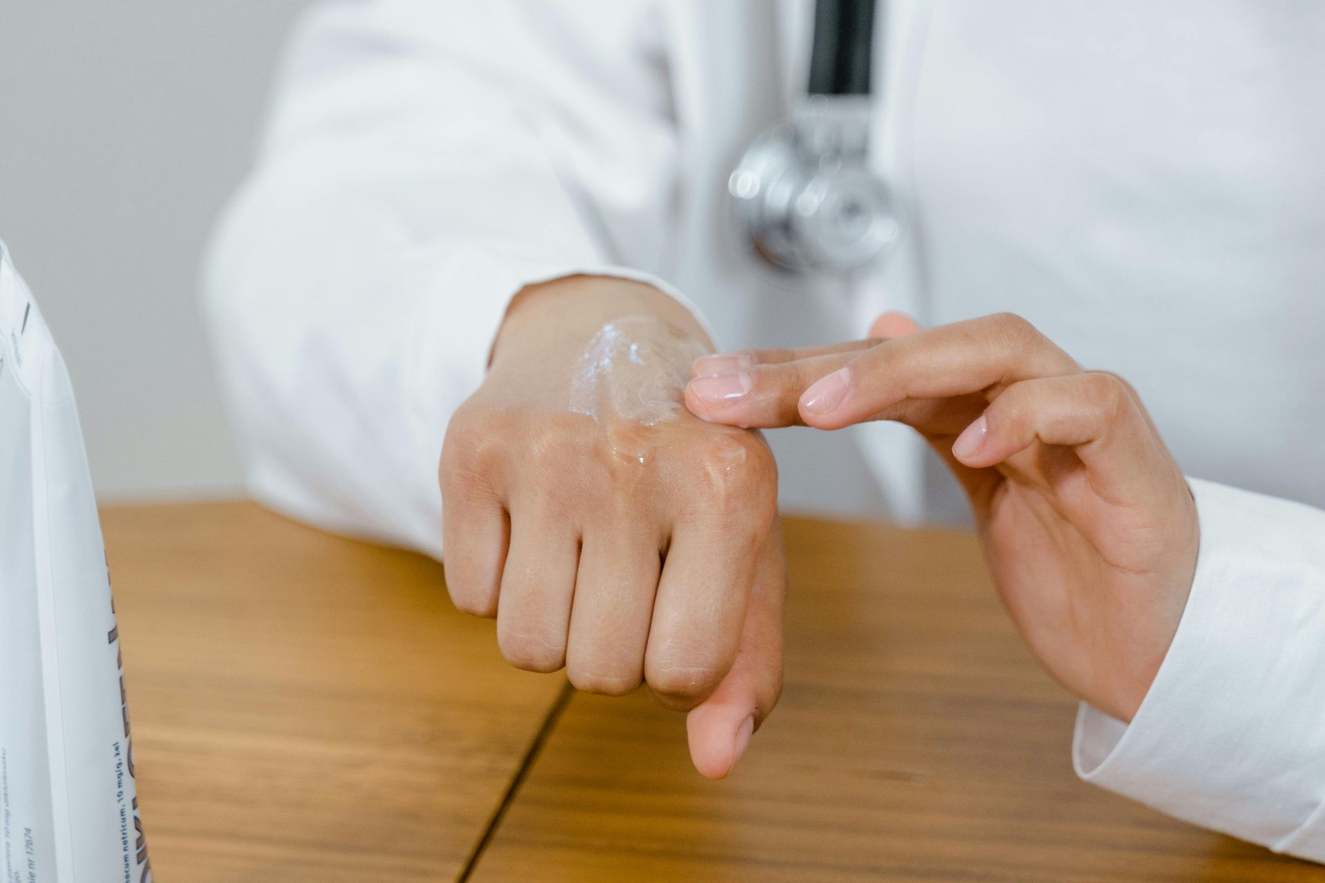 A doctor is applying a gel to his hand.