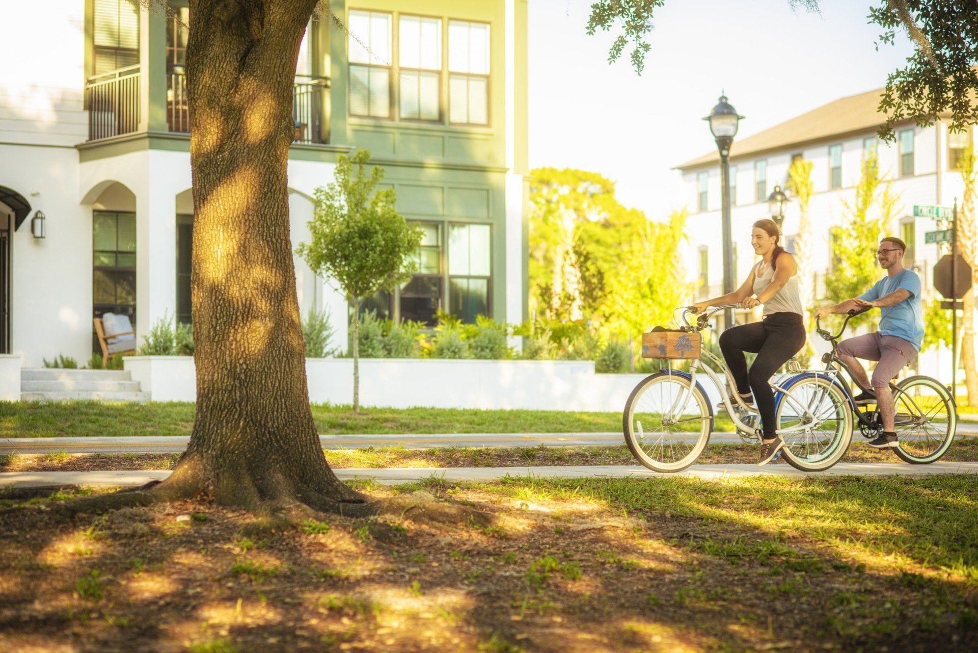 Photo showing two people riding bikes through the neighborhoo