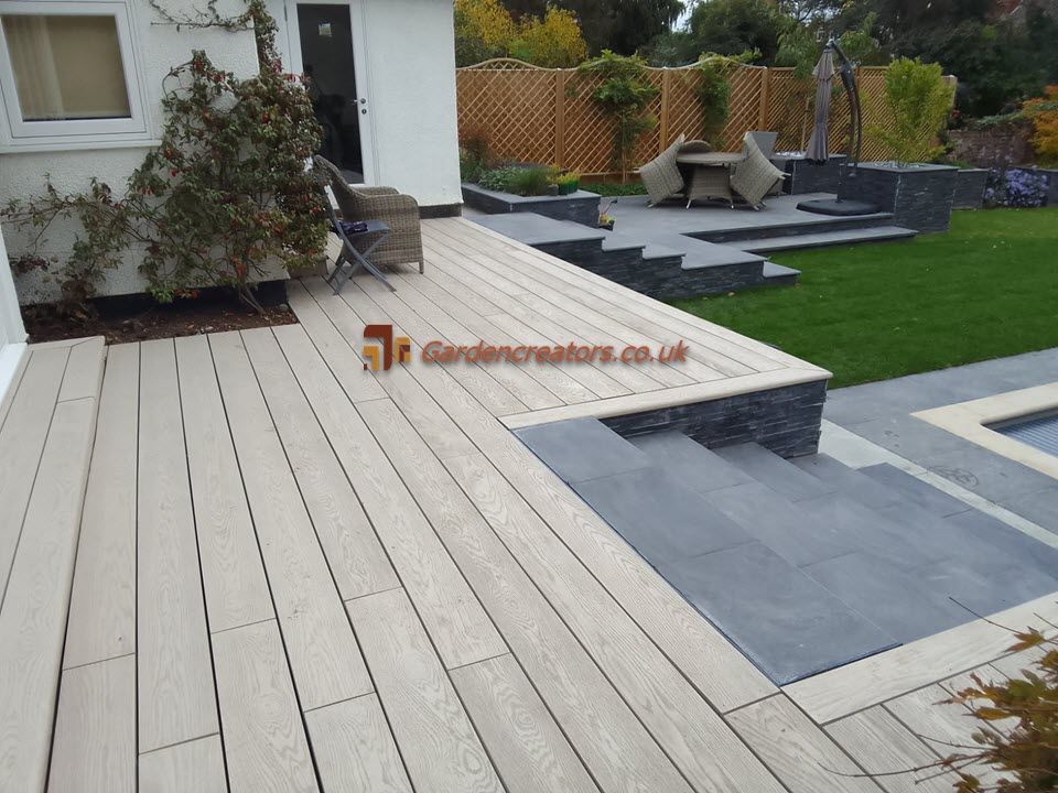 A composite decking near house and paving patio around pool