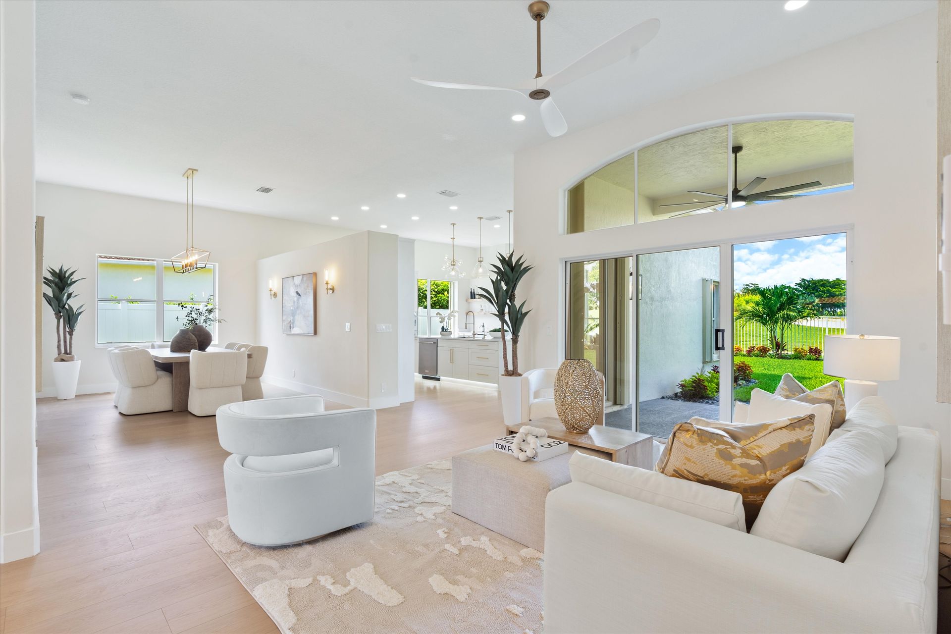 A living room filled with furniture and a ceiling fan.