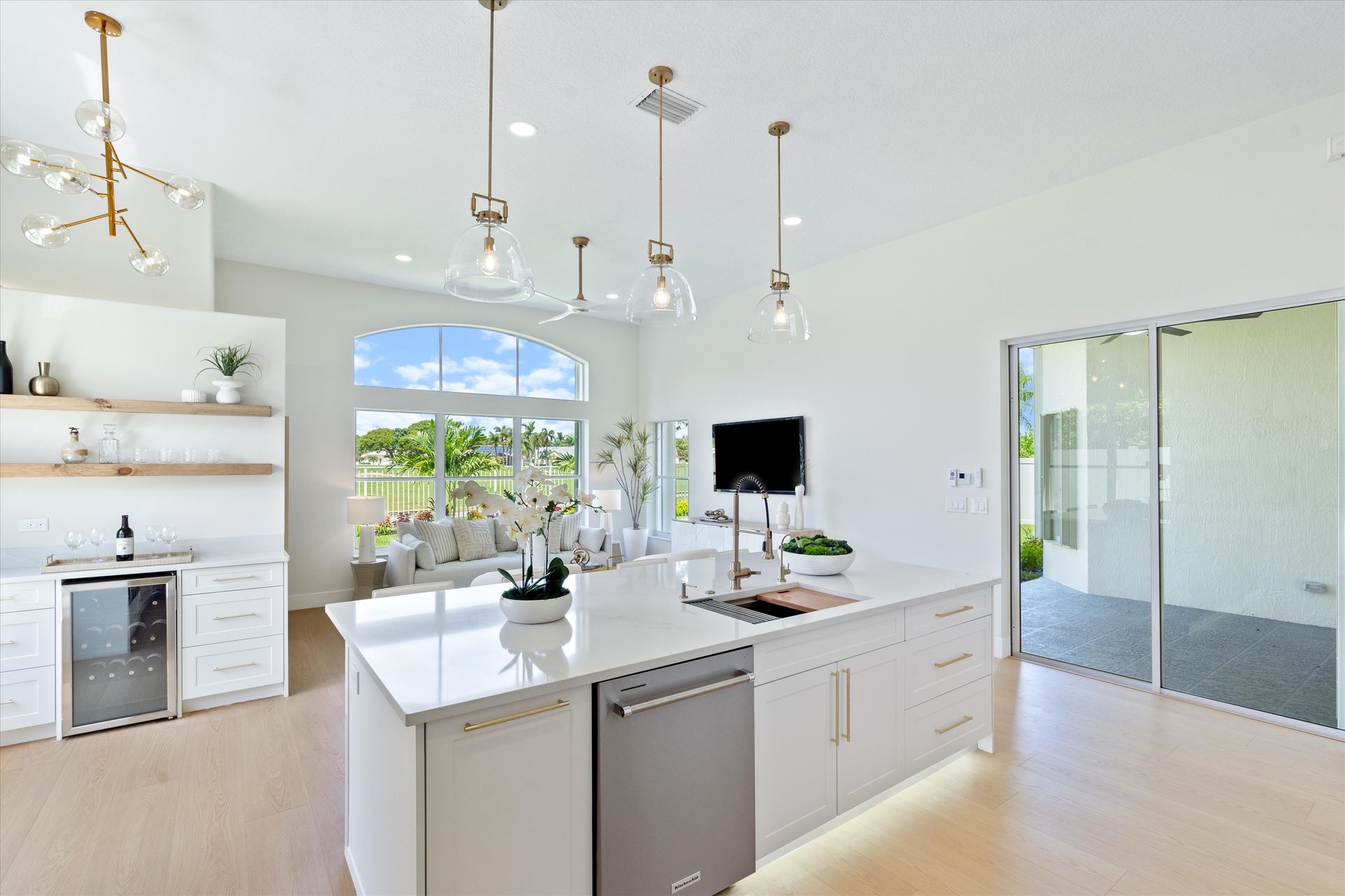 A kitchen with a large island and a stainless steel dishwasher.
