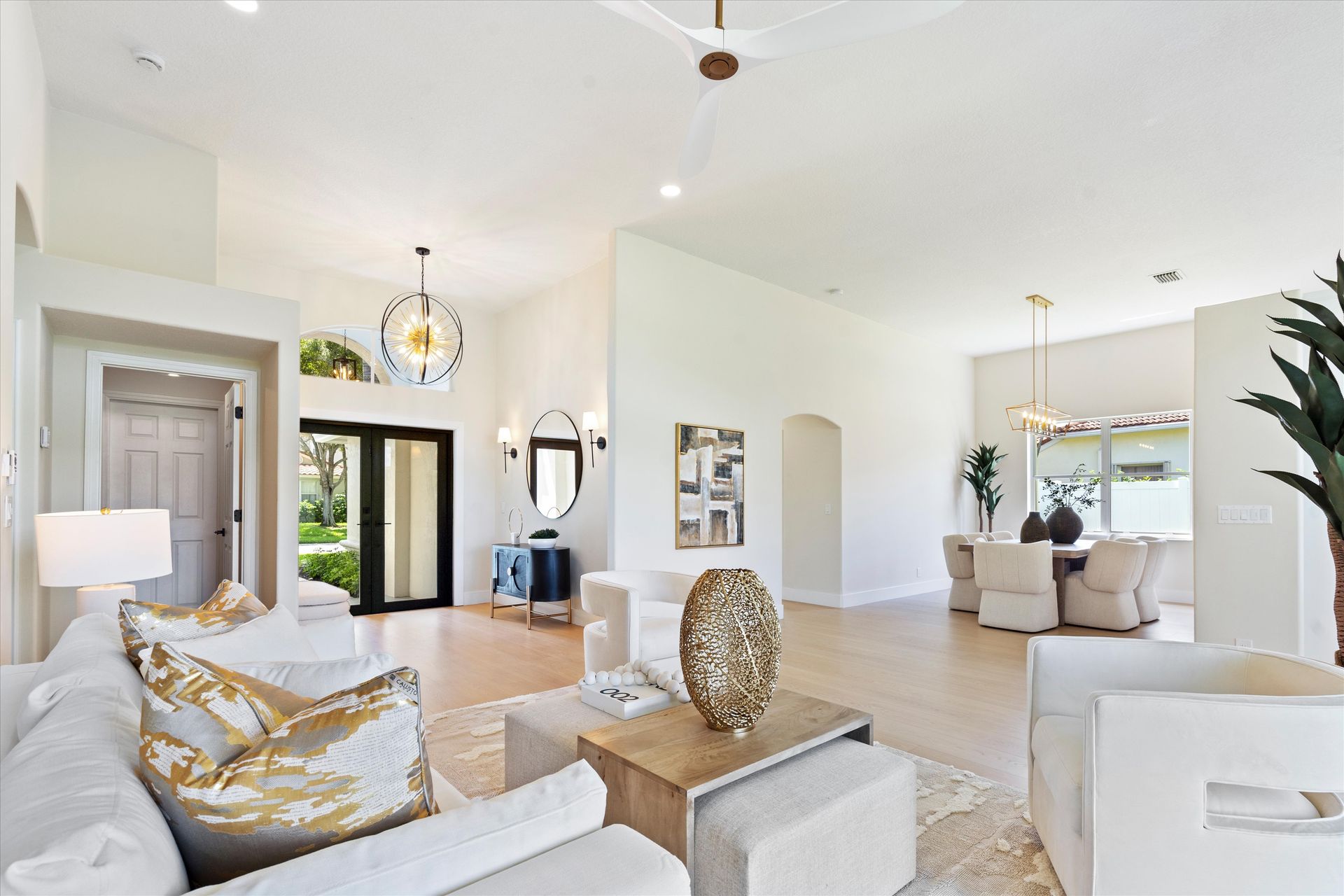 A living room with a couch , chairs , and a table.