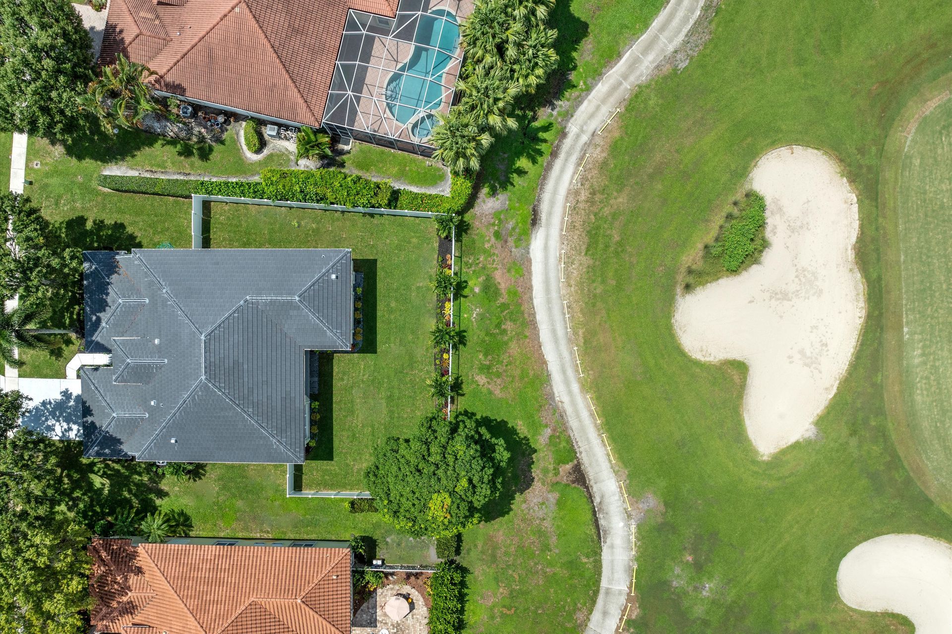 An aerial view of a house and a golf course