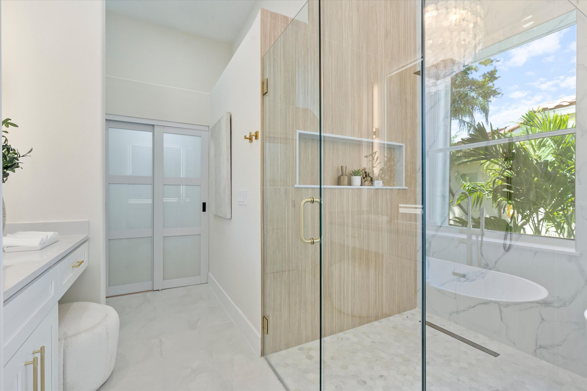 A bathroom with a walk in shower and a bathtub.