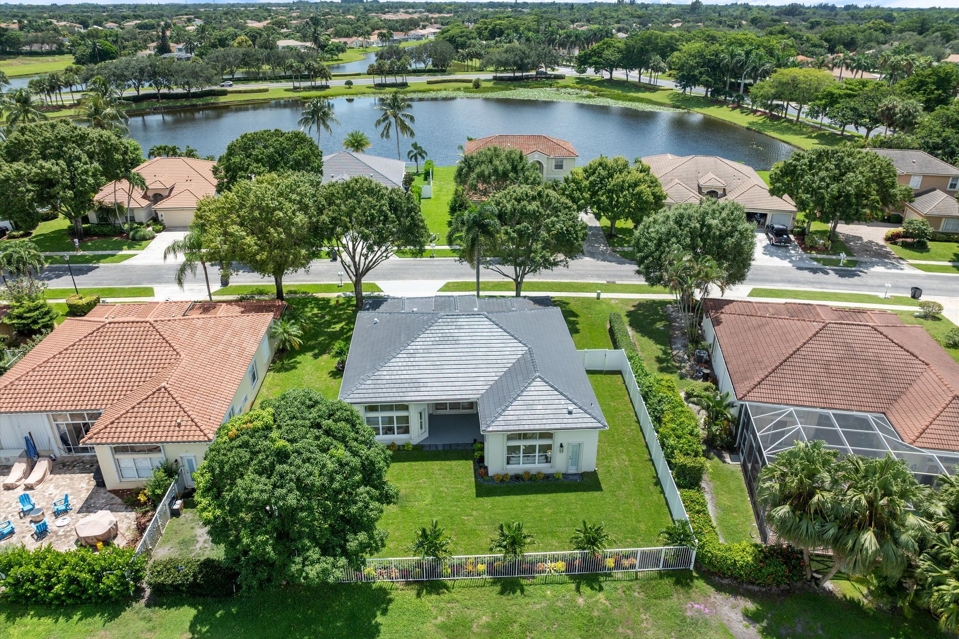 An aerial view of a house with a lake in the background