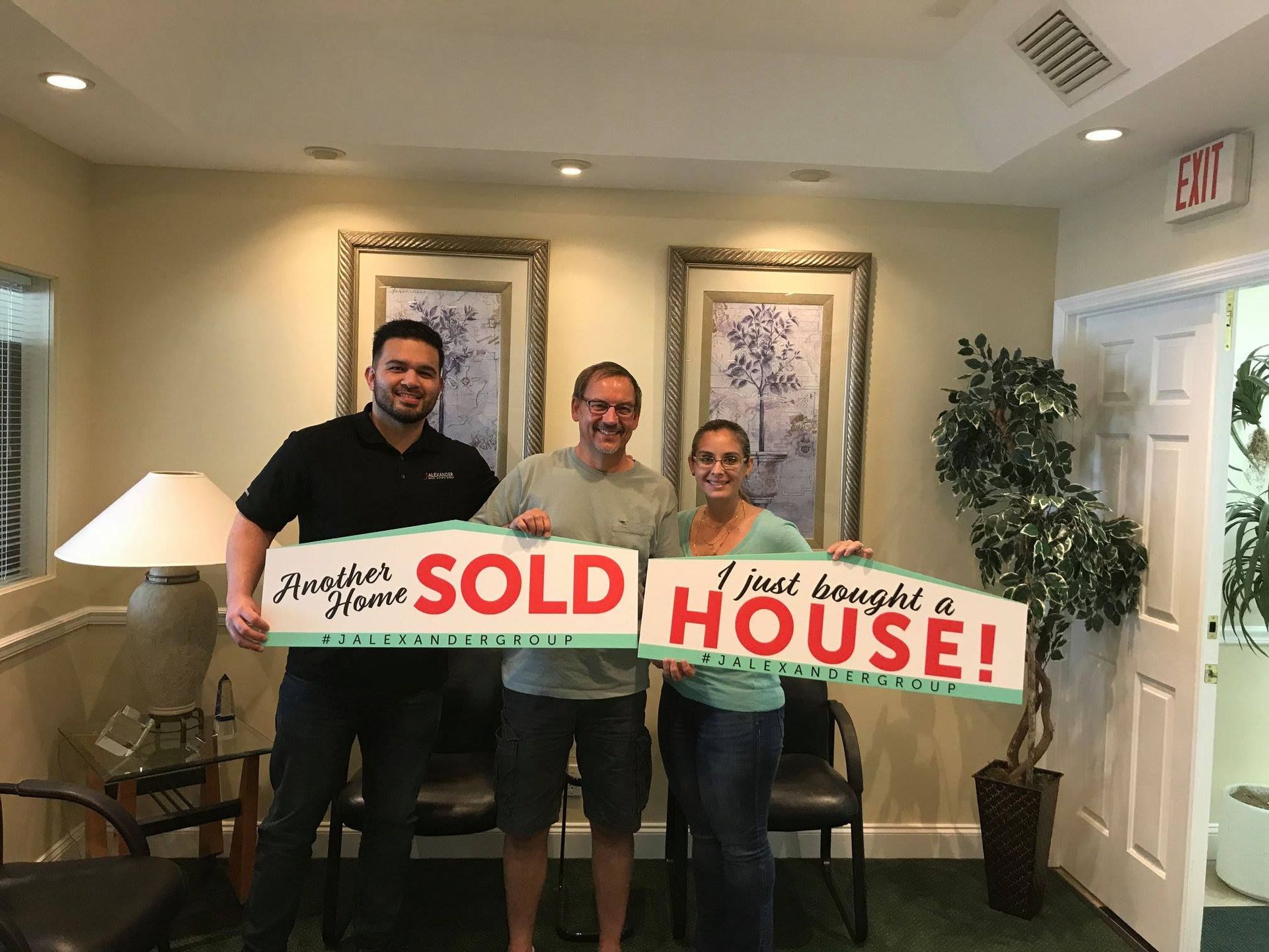 A group of people are holding signs that say `` i just bought a house ''.
