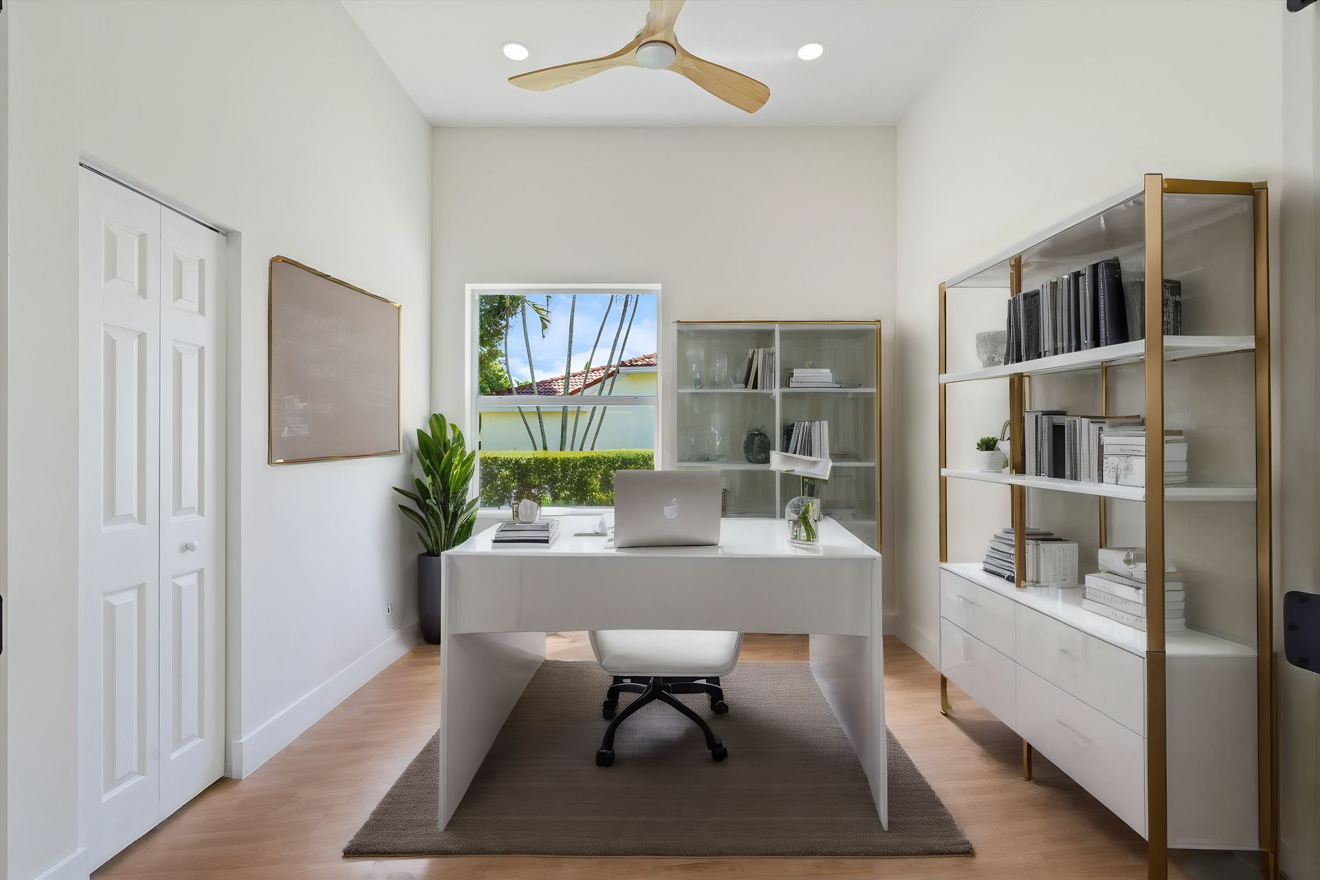 A home office with a desk and chair and a ceiling fan