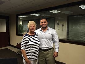 A man and a woman are posing for a picture in a room.