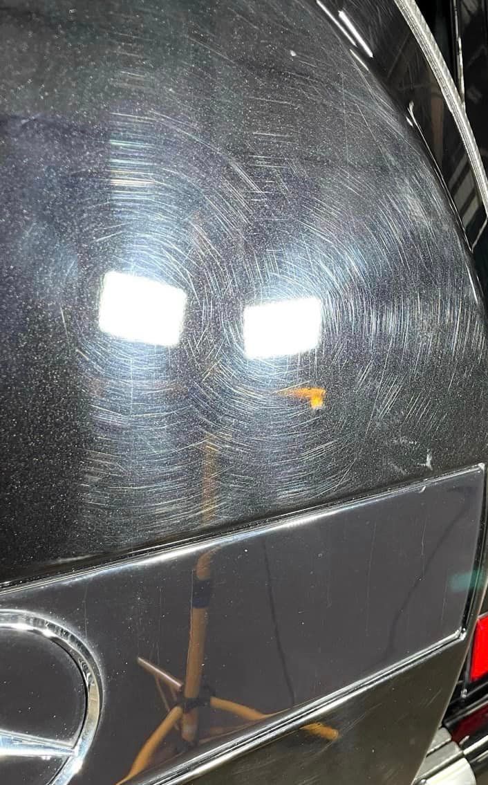 A close up of a black car with a lot of scratches on it before getting Bob Moses ceramic coating, Sensha World Crystal Glow