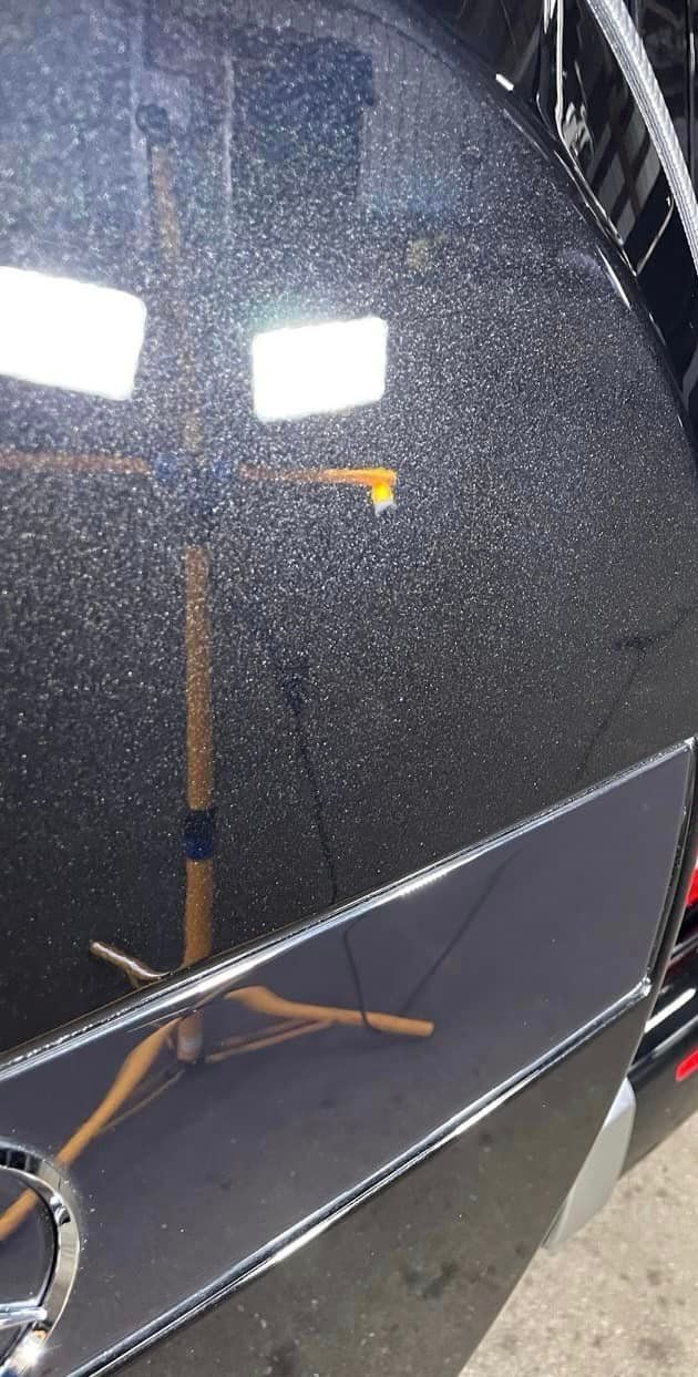 A close up of a black car with no scratches on it with Bob Moses ceramic coating, Sensha World Crystal Glow