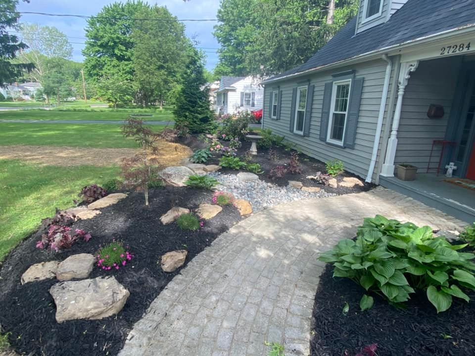 there is a walkway leading to the front of the house .