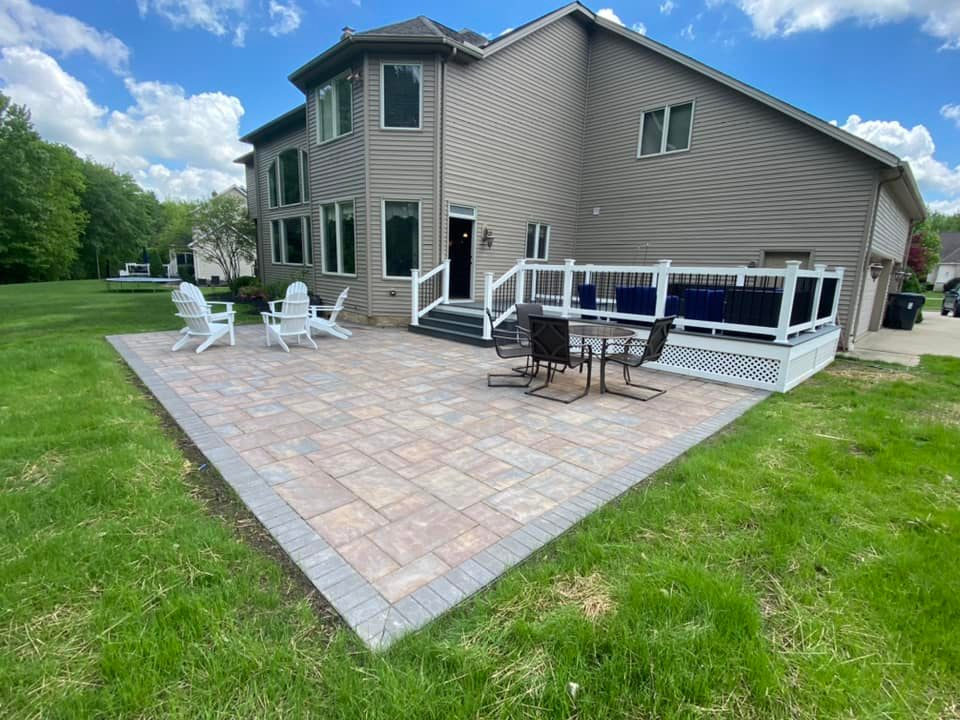 a large house with a patio and chairs in front of it .