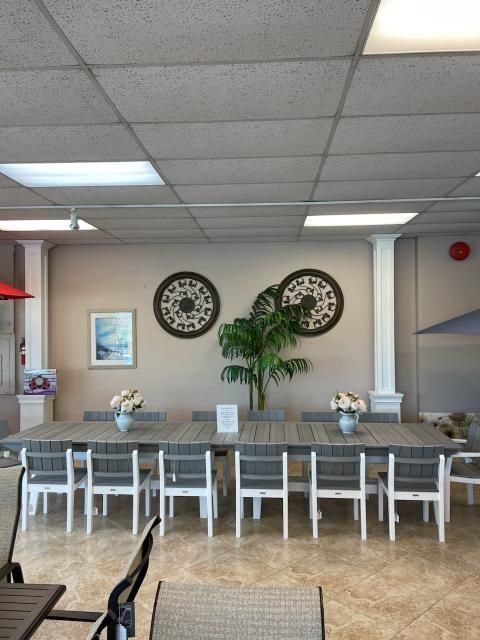 A large room with tables and chairs and two clocks on the wall
