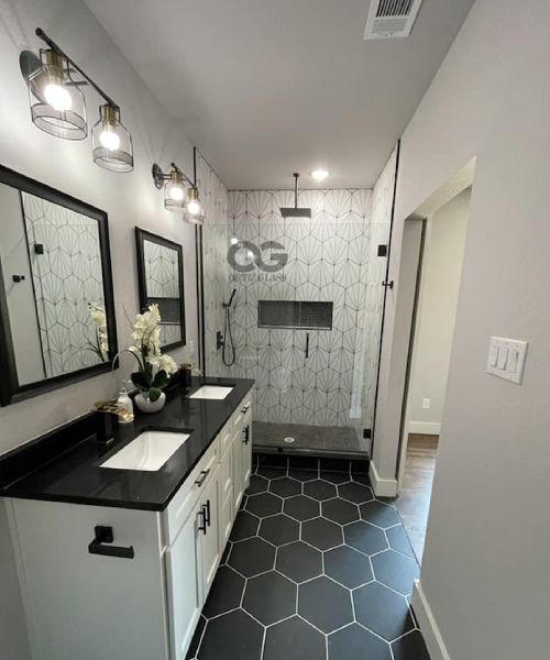 A bathroom with two sinks and a walk in shower.